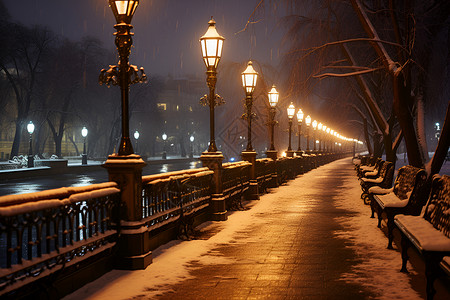 夜晚雪景中的长椅与街灯背景图片