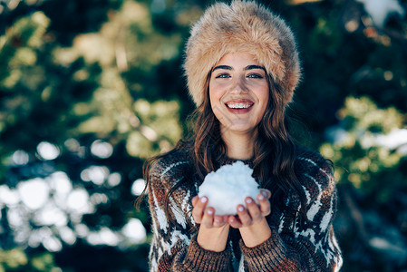 年轻的女人冬天享受雪山,内华达山脉,格拉纳达,西牙穿冬天衣服的女人玩雪年轻的女人冬天享受雪山背景图片
