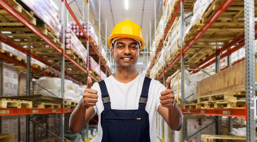 专业,物流业务人的快乐的微笑印度工人或装载机头盔大拇指仓库背景快乐的印度工人仓库里竖起大拇指图片