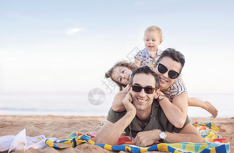 欢快轻松的家庭美丽的海滩上摆姿势图片