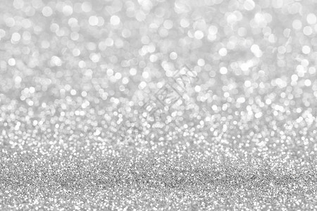 闪亮的银波克闪光灯抽象背景,圣诞新年派庆祝闪亮的银色灯光背景图片