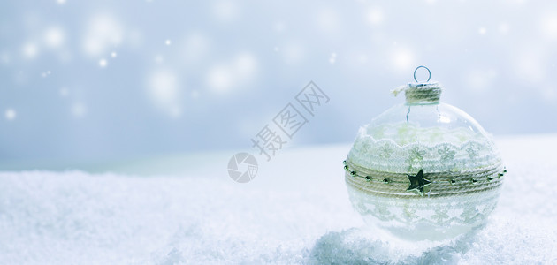 圣诞装饰玻璃球雪中蓝色明亮的背景雪中的圣诞玻璃球图片
