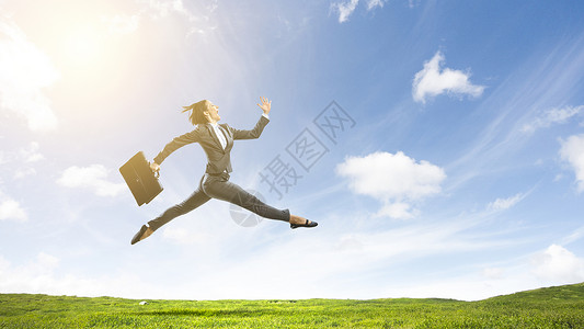 欢快的女商人自然背景下跳跃巨大的成功跳跃图片