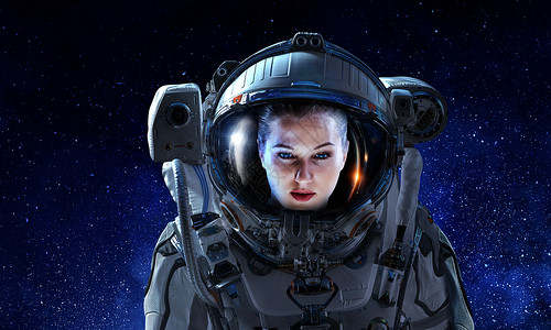 黑暗星空背景下女宇航员的肖像穿着太空服的有魅力的女人背景图片