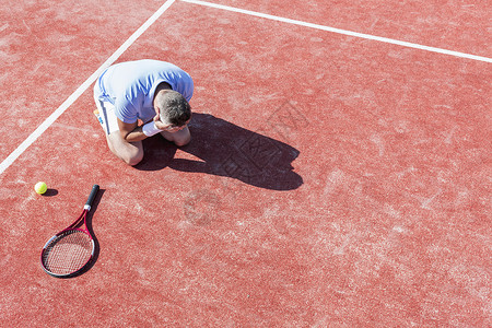 高角度的,失望的成熟男子,头双手,而跪网球拍红场夏天图片
