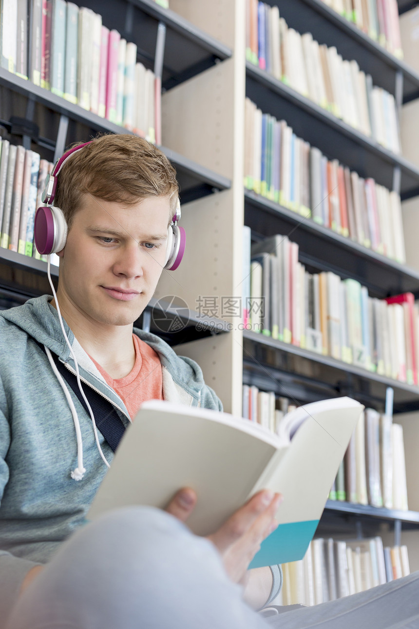 学生图书馆听书架上的音乐时读书图片