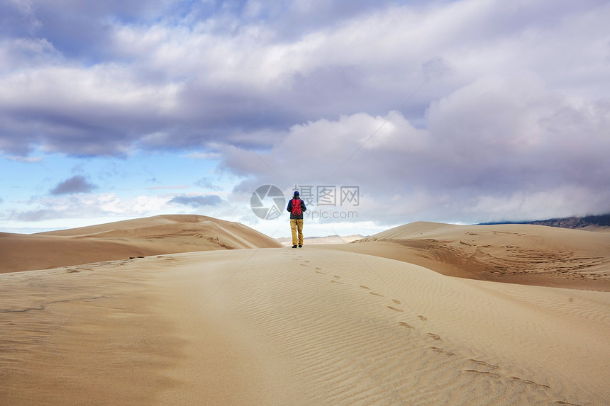 沙漠沙丘中的徒步旅行者图片