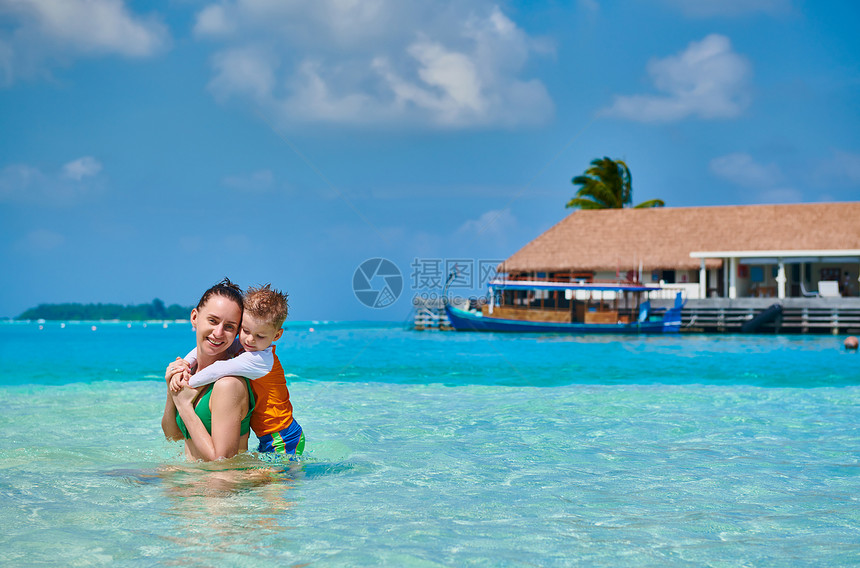 三岁的蹒跚学步的男孩海滩上母亲浅水中玩马尔代夫的暑假家庭假期图片