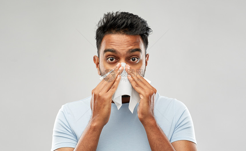 健康问题,鼻炎过敏健康的印度男人用纸巾鼻子灰色背景印度男人用纸巾鼻子图片