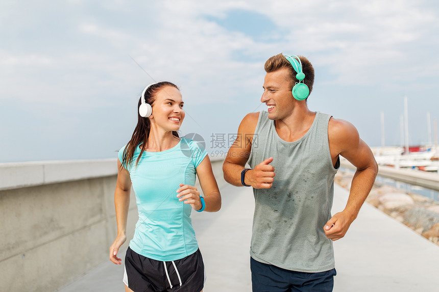 运动,人技术快乐的夫妇与耳机健身跟踪器运行户外耳机户外运行图片