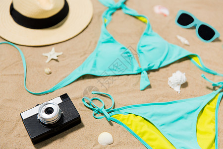 贝壳泳衣假期,旅行夏季比基尼,帽子,相机太阳镜与贝壳海滩沙滩海滩沙滩上的比基尼,相机太阳镜背景