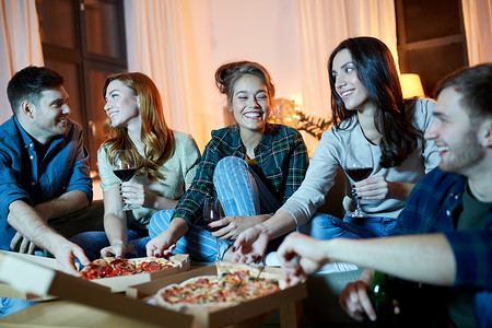 友谊食物休闲快乐的朋友晚上家吃比萨饼喝含酒精的红酒朋友家吃披萨喝红酒背景图片