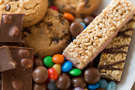 棒糖糖果食物,垃圾食品健康的饮食巧克力,燕麦饼干,滴糖果穆斯利棒盘子里巧克力,饼干,糖果穆斯利棒背景
