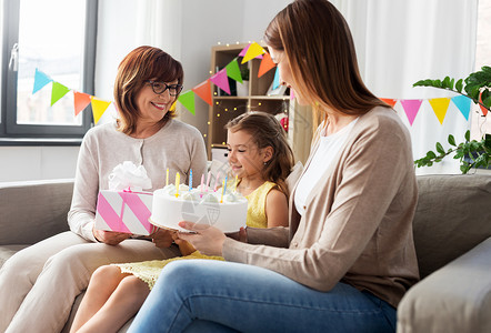 家庭,世代庆祝微笑的母亲,女儿祖母与生日蛋糕礼品盒家里母亲女儿祖母生日图片
