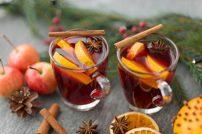 诞节季节的待遇璃热覆盖葡萄酒与橙色片,苹果冷杉枝灰色背景杯热覆盖的葡萄酒,饼干,苹果冷杉图片