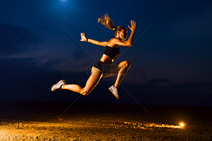 轻的体育女子高跳户外黄昏训练轻的体育女图片
