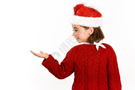 可爱的小女孩戴着诞老人的帽子,隔离白色的背景上诞节的冬天衣服背景图片