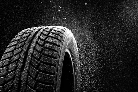 雪黑色的背景上扫过冬天的轮胎盖雪地里的橡胶高清图片