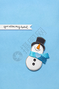 个雪人蓝色背景上用纸的创意照片图片