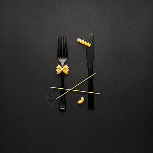 黄色黑色叉子美味的意大利创造的静物照片叉子勺子与生意黑色背景背景