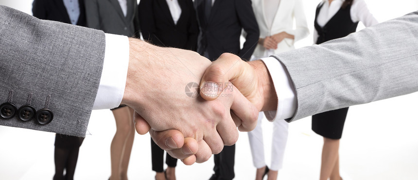 商人握手商人握手,他们的队站后台图片