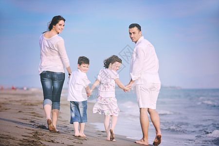 快乐的轻家庭海滩上享受快乐健康的生活方式图片