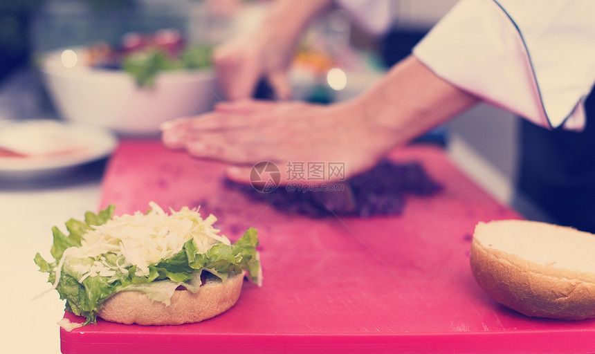 主厨餐厅厨房里为汉堡切沙拉厨师手切沙拉汉堡图片
