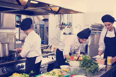 专业队厨师厨师繁忙的酒店餐厅厨房准备饭菜队厨师厨师准备饭菜图片