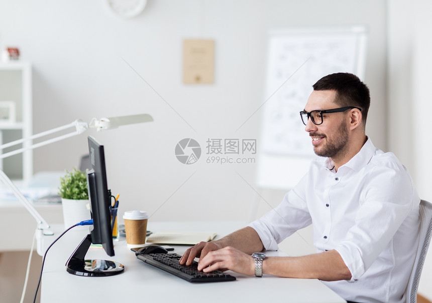 商业,人技术快乐的商人办公室的电脑键盘上打字的眼镜商人办公室电脑键盘上打字图片
