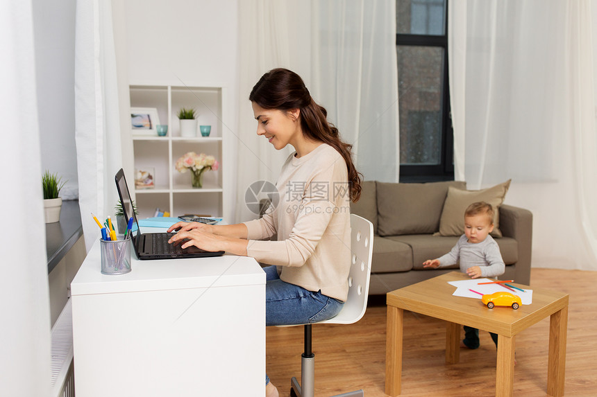母亲,多任务,家庭技术快乐的母亲与婴儿笔记本电脑家里工作快乐的母亲带着孩子笔记本电脑家工作图片