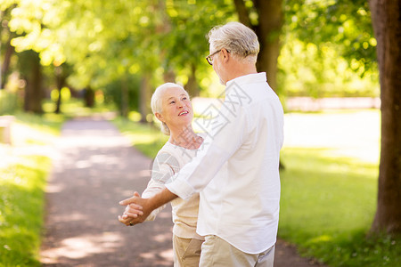 老,关系人的快乐的老夫妇夏季公园跳华尔兹快乐的老夫妇夏季公园跳舞背景图片