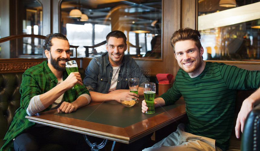 人们,休闲帕特里克日的快乐的男朋友酒吧酒吧喝绿色啤酒男朋友酒吧酒吧喝绿色啤酒图片