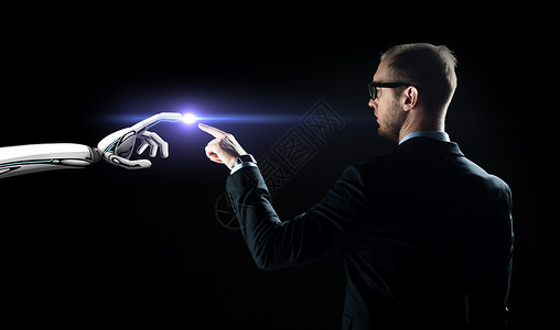 商业,未来技术人工智能商人机器人手与闪光灯黑色背景机器人人类的手闪过黑色的光背景