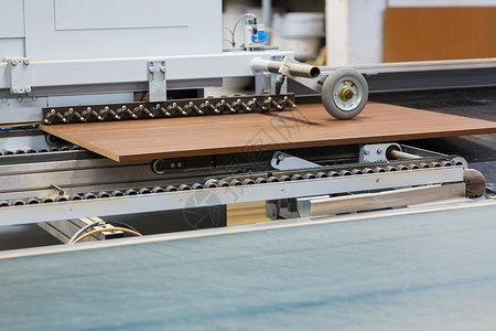 生产制造木工行业家具厂车间输送机上的纸板加工家具厂输送机上的排屑板背景图片