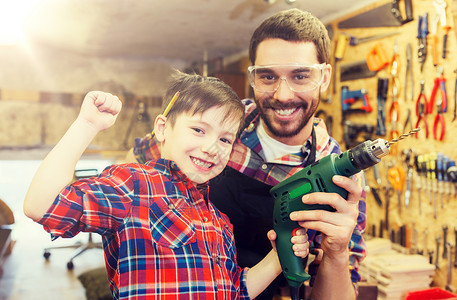 家庭,木工,木工人的快乐的父亲小儿子与钻车间工作父亲儿子车间工作图片