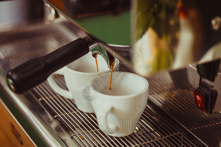 饮料制作两杯咖啡自动咖啡机生产两种芬芳的咖啡背景