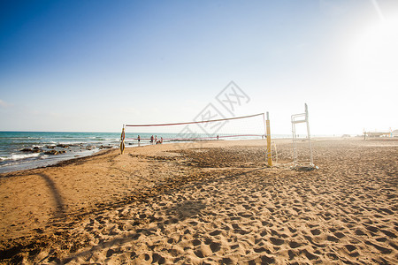 海岸素材网排球网阳光明媚的沙滩上,群人夏天的背景下排球网活动娱乐活动背景