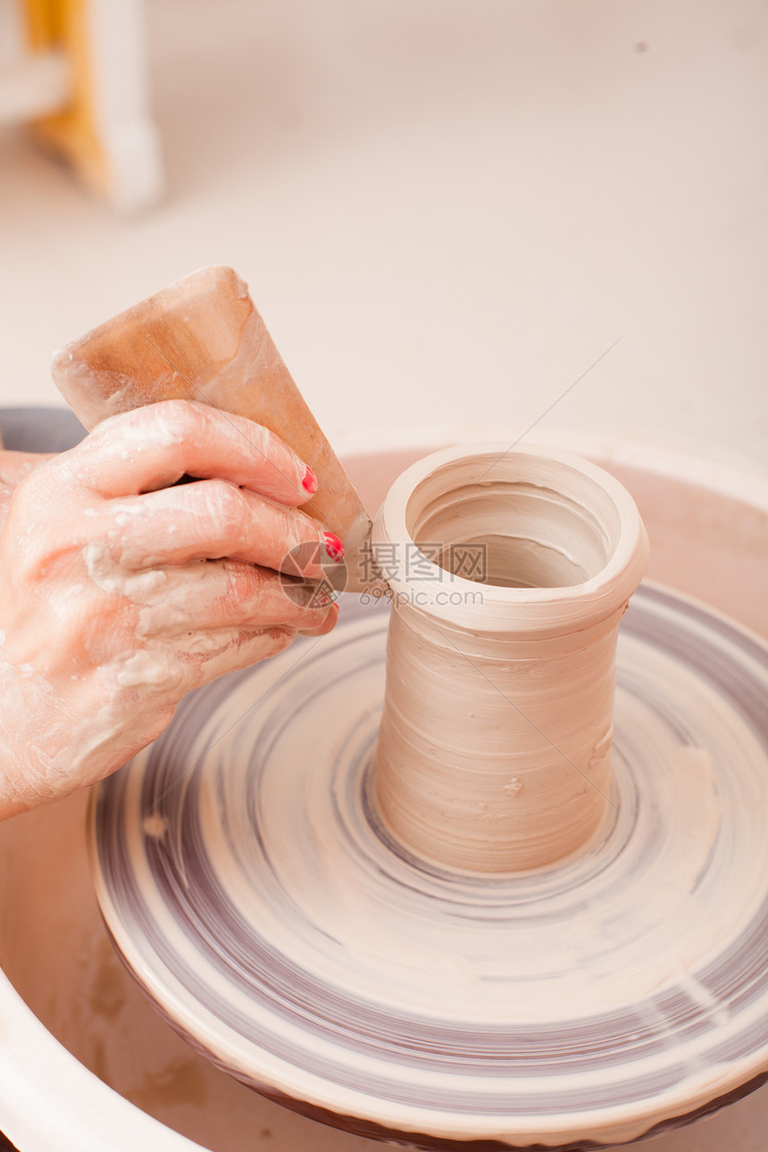 儿童陶瓷工艺品用白色粘土陶工轮上制作陶器的女孩的手儿童陶瓷工艺品图片