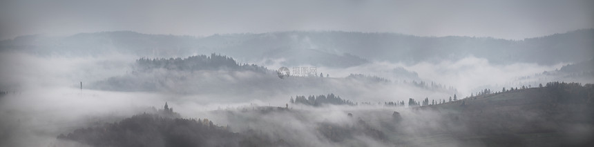 山上秋雨雾的全景薄雾坠落林地森林云雾中的山丘上图片