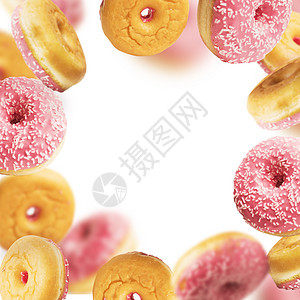 坠落飞行粉红色釉甜甜圈与洒运动的背景,框架图片