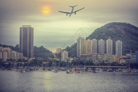 这架飞机正巴西里约热内卢上空飞行穿过海湾的城市景色图片