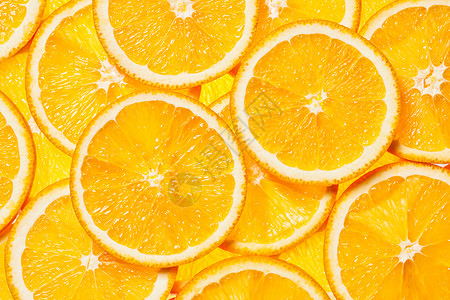 彩色橙色柑橘类水果片背景背光五颜六色的橙色水果片图片
