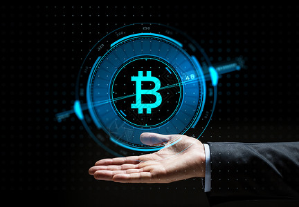 乔尼斯加密货币金融技术商业Buisnessman手与虚拟比特币符号全息图黑色背景上布尼斯曼手与比特币全息图设计图片