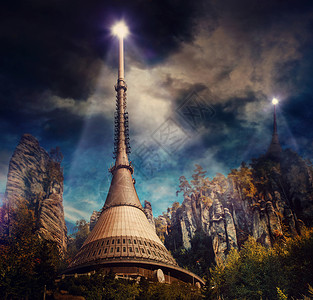 星球上的未来主义殖民站高塔粗糙的岩石上,顶部明亮的灯光图片