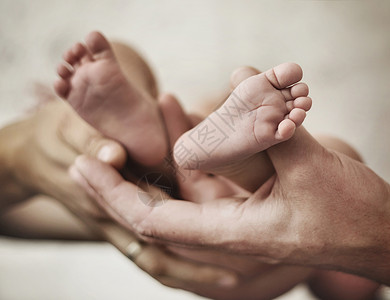 父母给婴儿的小脚镀金的图片图片