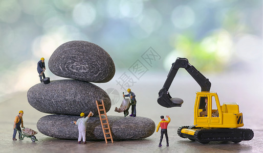 绿色生态小公民鹅卵石堆叠工人雕像背景