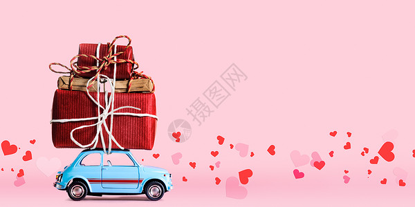 蓝色复古玩具汽车送礼品盒情人节粉红色背景与飞心图片