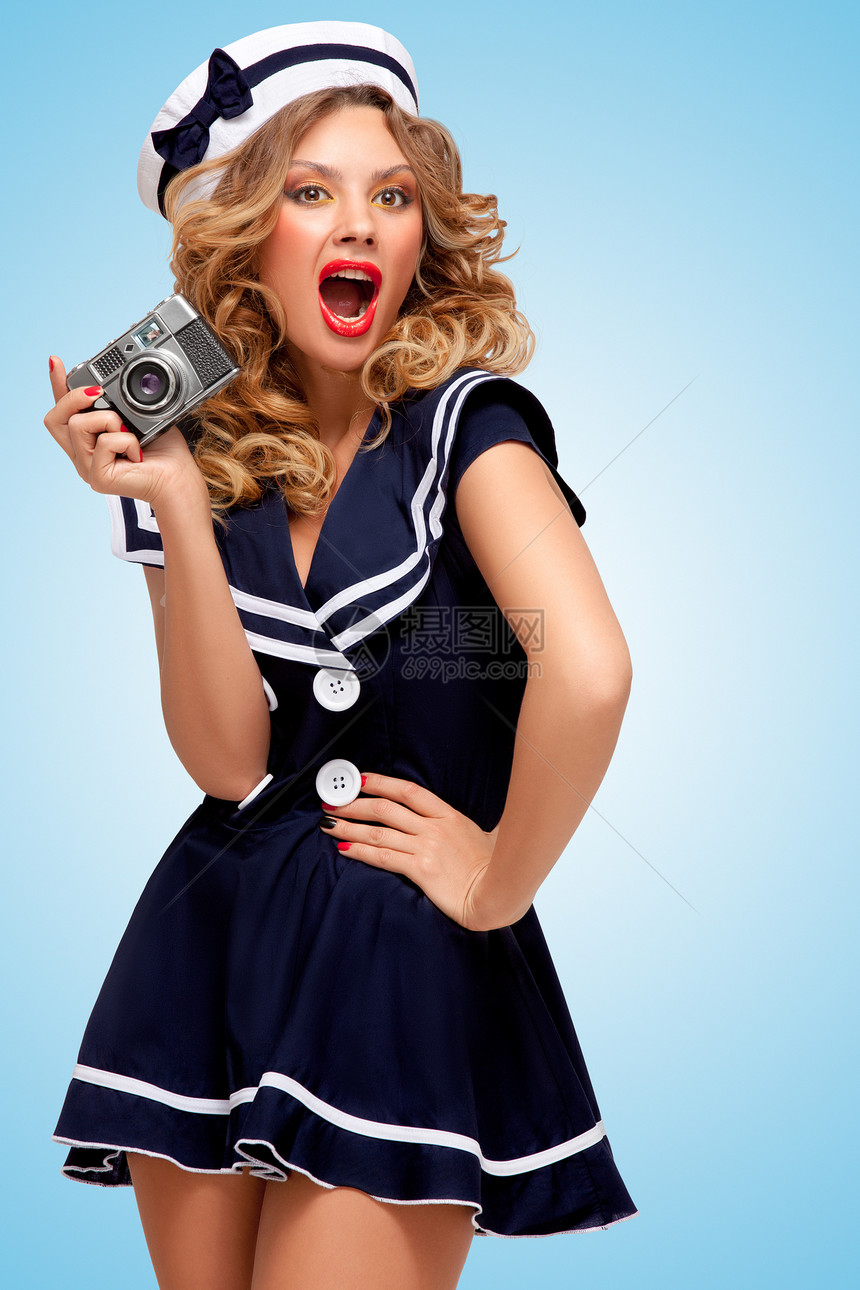 复古照片,个迷人的打扮水手女孩与个旧的老式照片相机情绪蓝色背景图片