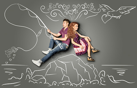 快乐情人节的爱情故事,浪漫的夫妇坐个岛上,粉笔画背景的钩子上钓鱼金鱼图片