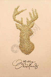 棕色背景上由金色装饰沙制成的鹿的创意照片图片